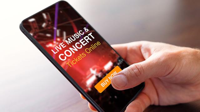 person buying a concert ticket online using a cell phone